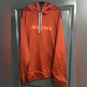 Patagonia burgundy Hoodie with orange lettering